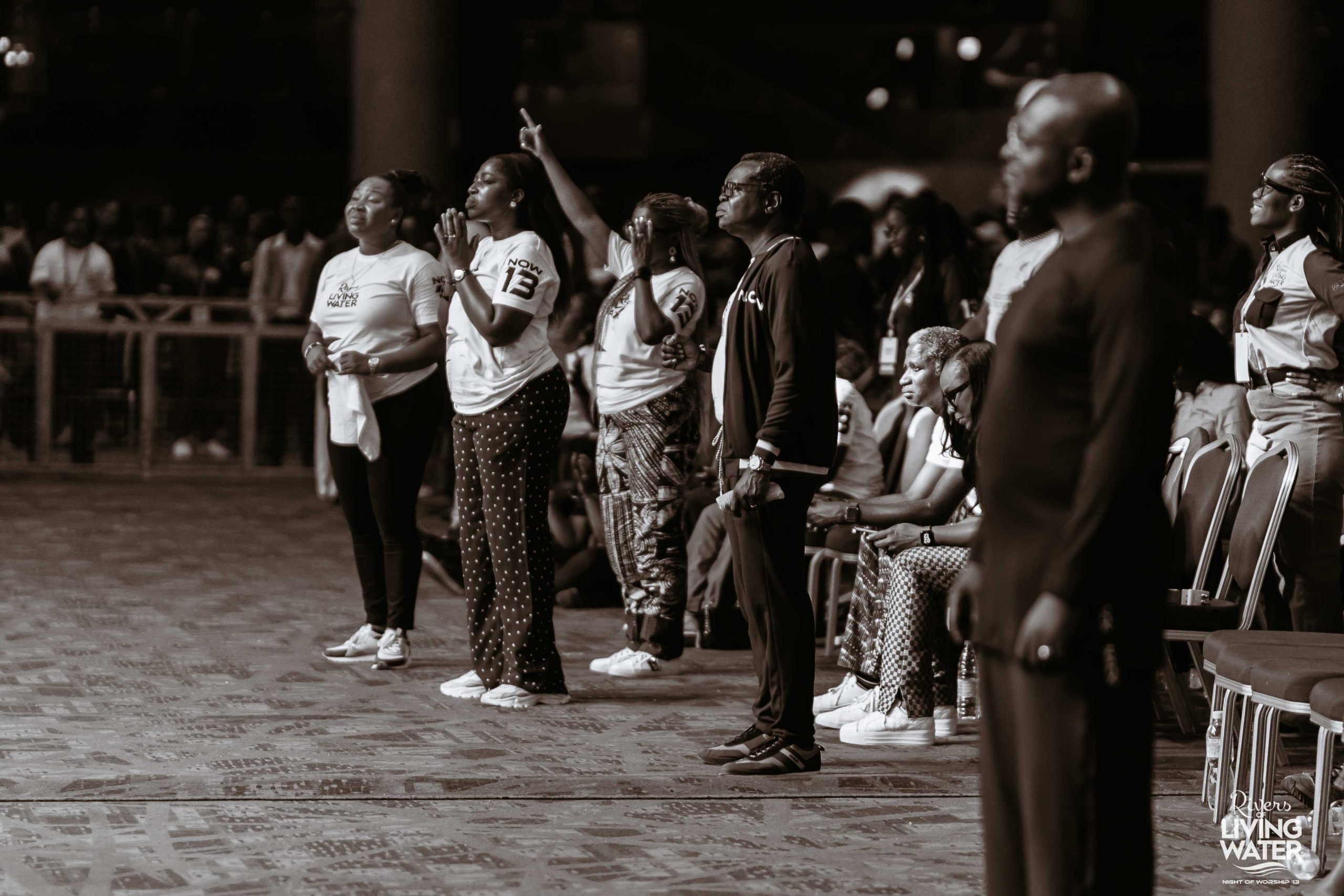Worshippers with hands raised at Night of Worship